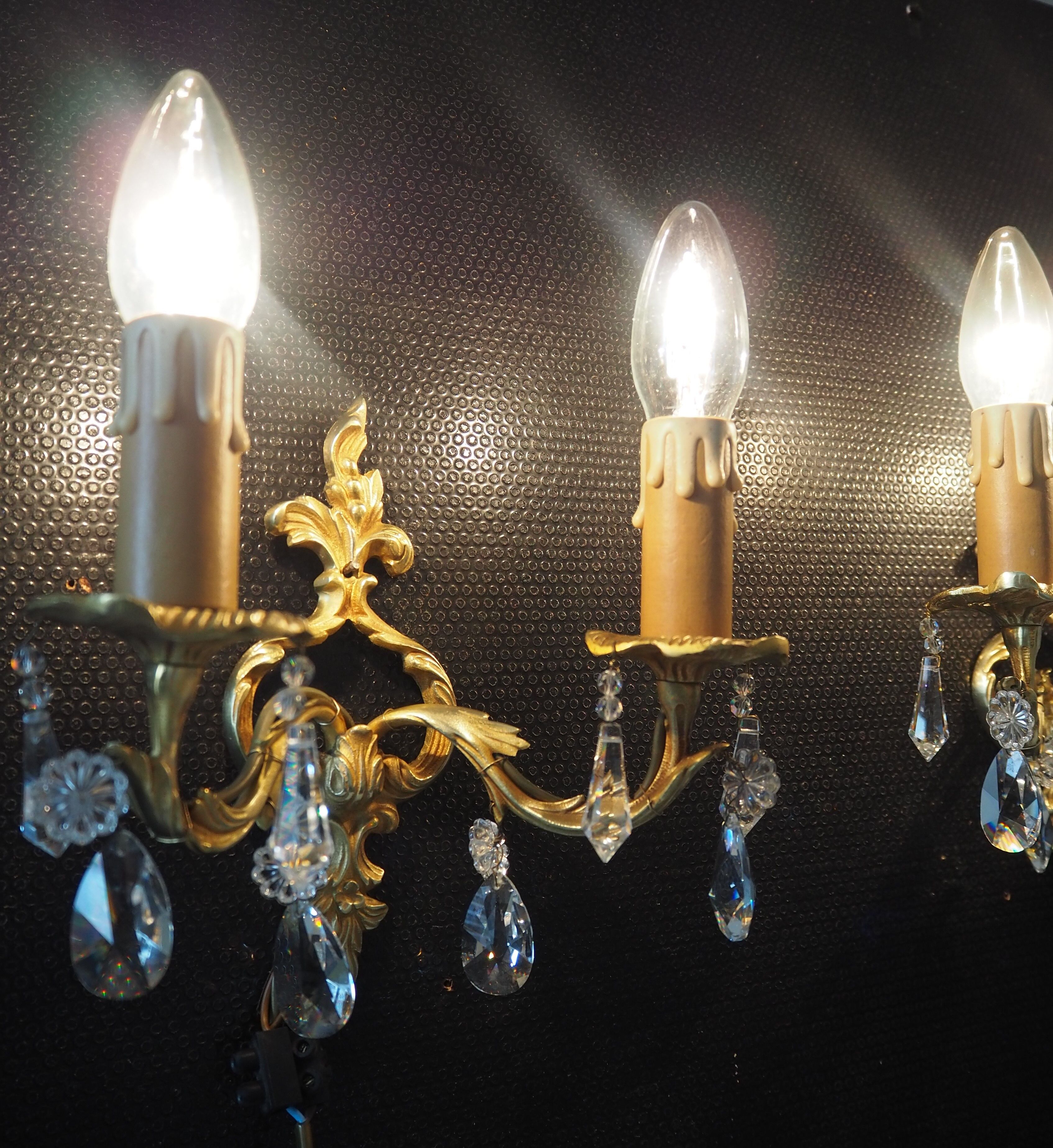 Pair of gilded bronze sconces and crystal pendants