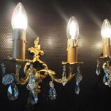 Pair of gilded bronze sconces and crystal pendants