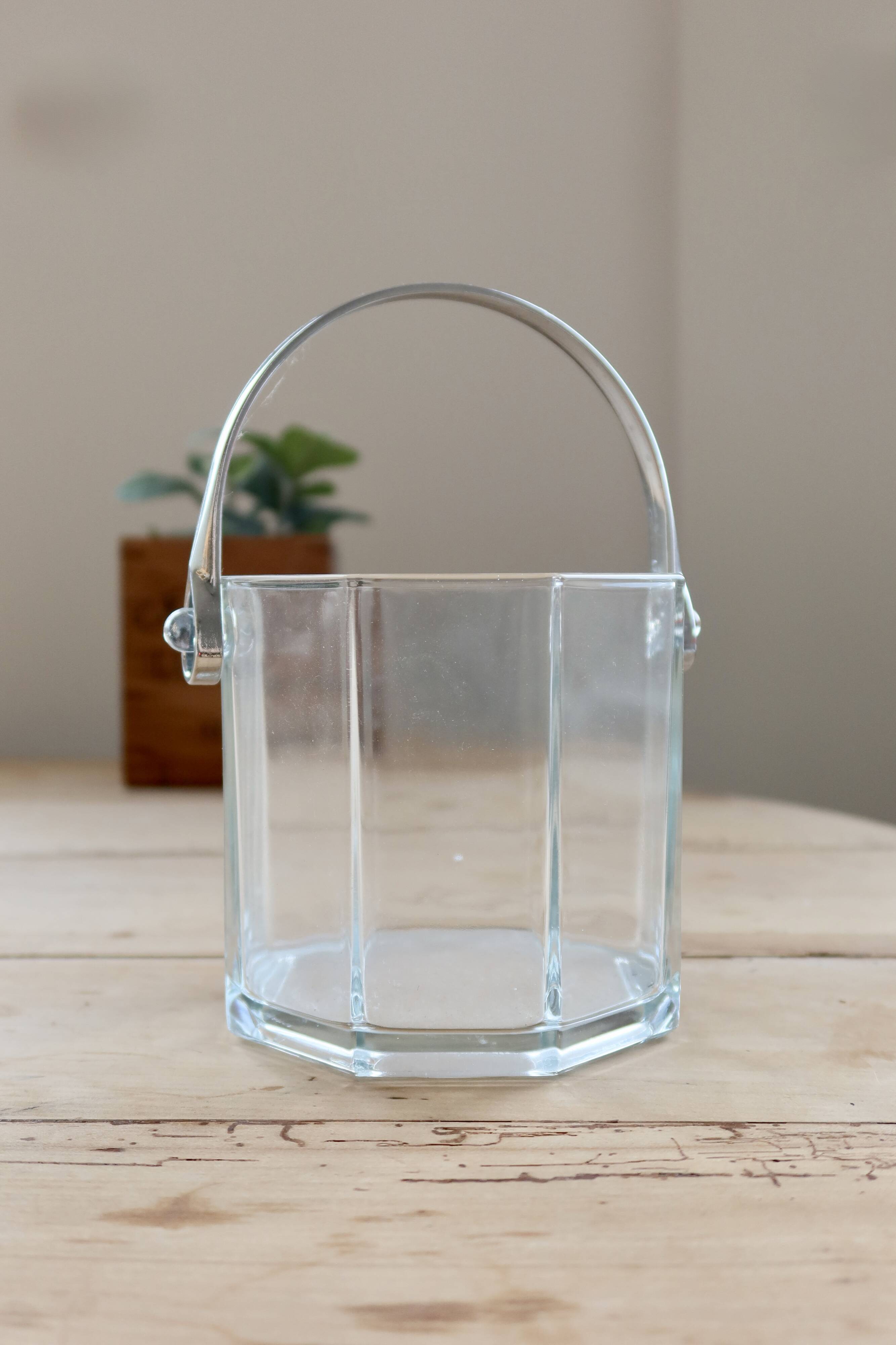 Vintage glass ice bucket with chrome handle.
