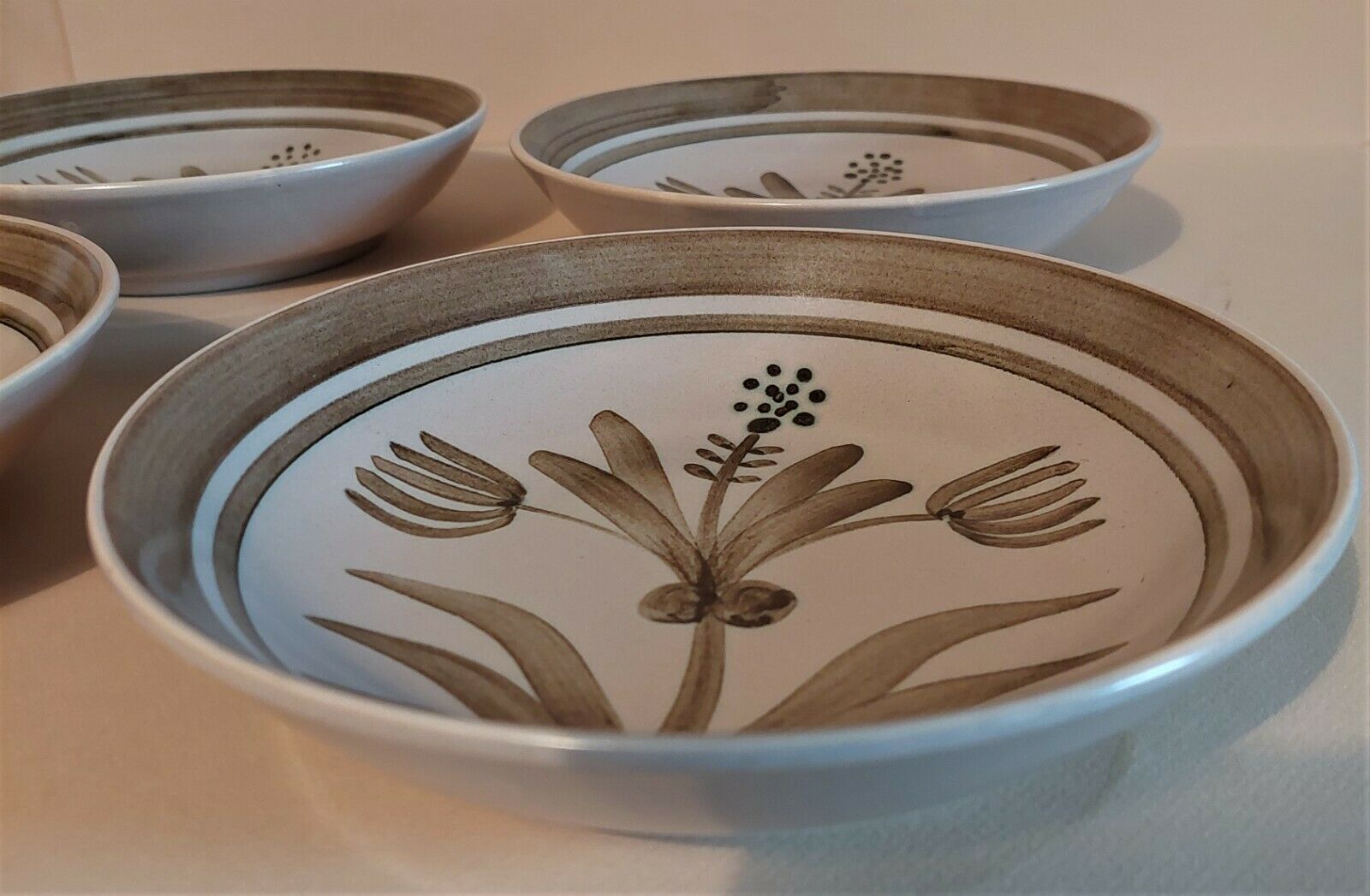 Vintage hollow plates in sandstone series of four marked Longchamp