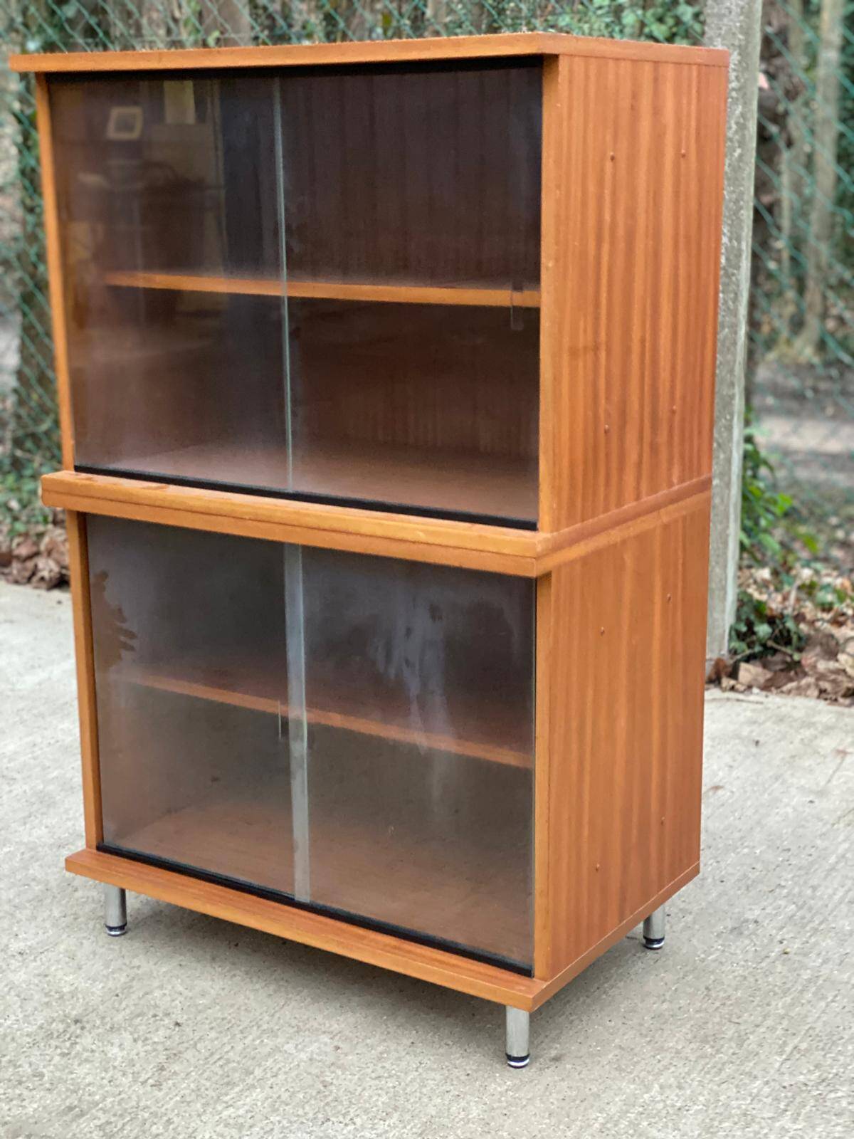 Scandinavian wooden buffet cabinet with sliding glass doors.
