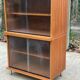Scandinavian wooden buffet cabinet with sliding glass doors.