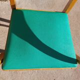 3 vintage bridge chairs with rounded armrests.