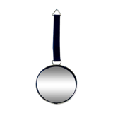 Vintage witch's eye curved mirror hangs velvet ribbon