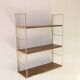 Golden wire shelf in metal with a wood effect.