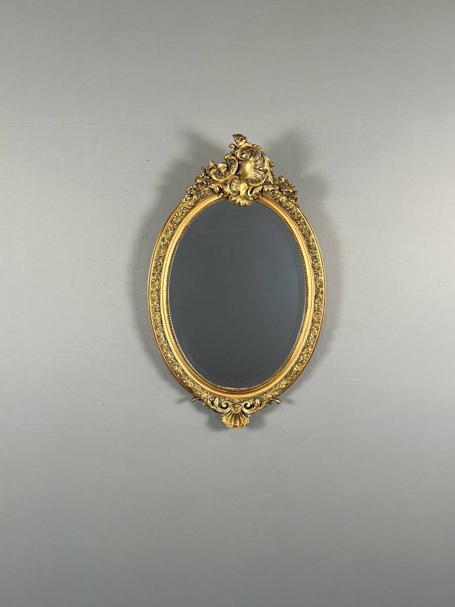 Oval gilded wooden mirror in Louis XV style, 19th century