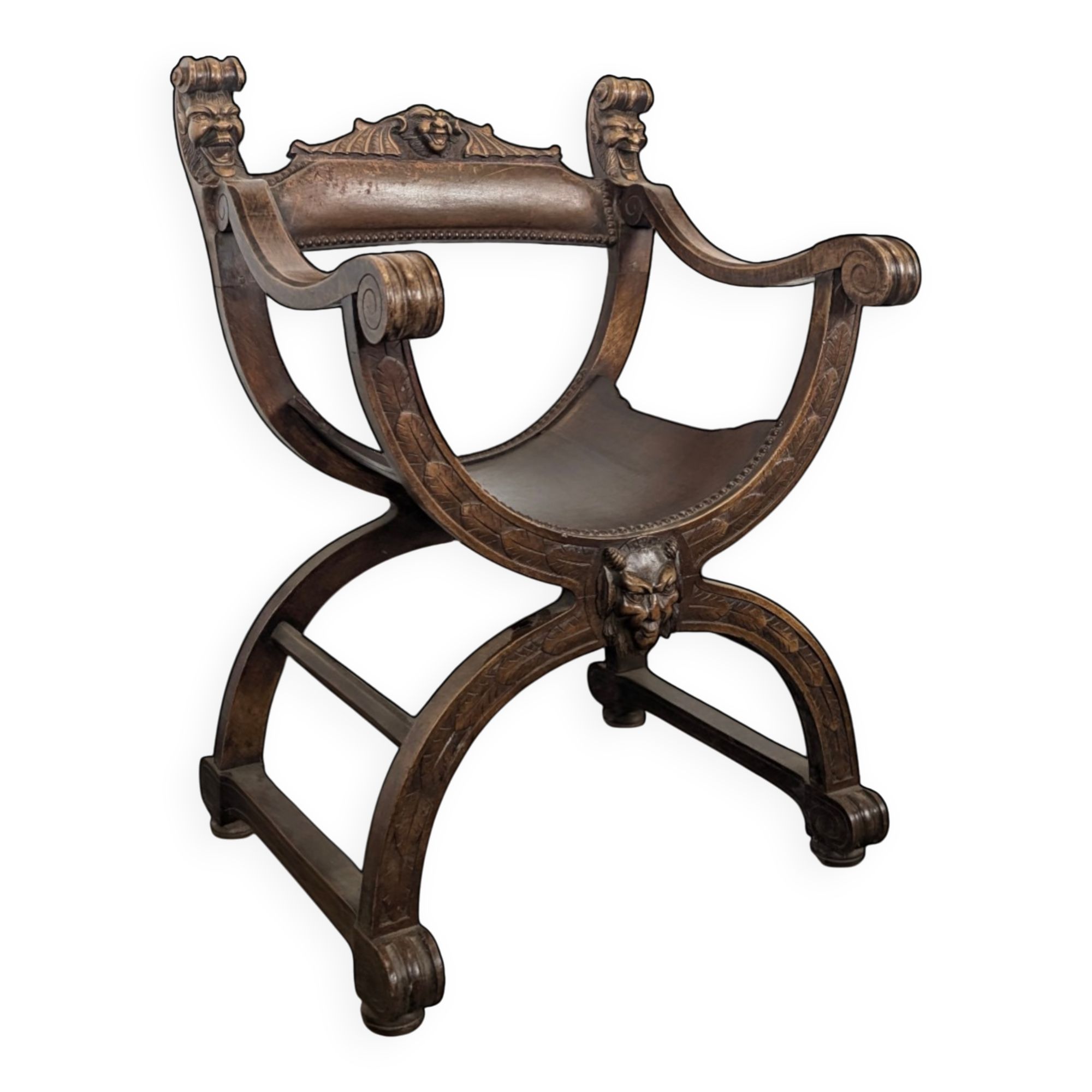 Curule chair Dagobert in carved walnut with lion heads.