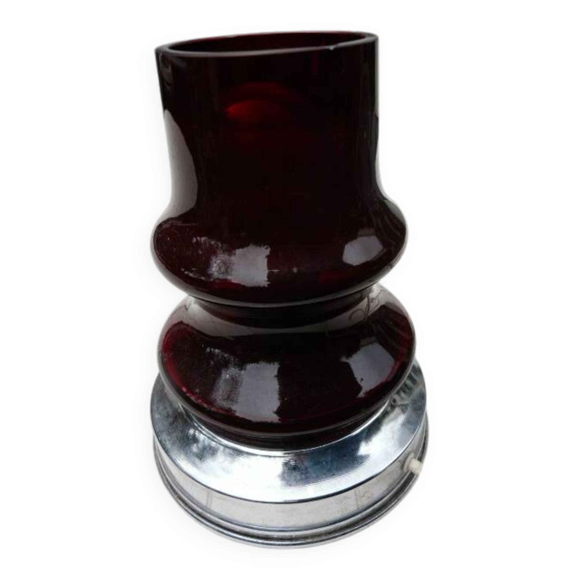 Red glass table lamp on a chrome base.