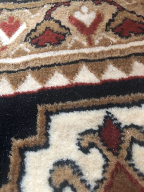 Wool carpet with oriental decoration on a brown background