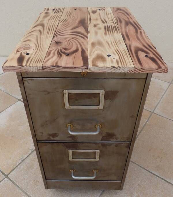 Vintage industrial metal furniture with a rusty effect, featuring two drawers on wheels.