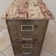 Vintage industrial metal furniture with a rusty effect, featuring two drawers on wheels.