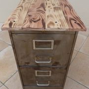 Vintage industrial metal furniture with a rusty effect, featuring two drawers on wheels.