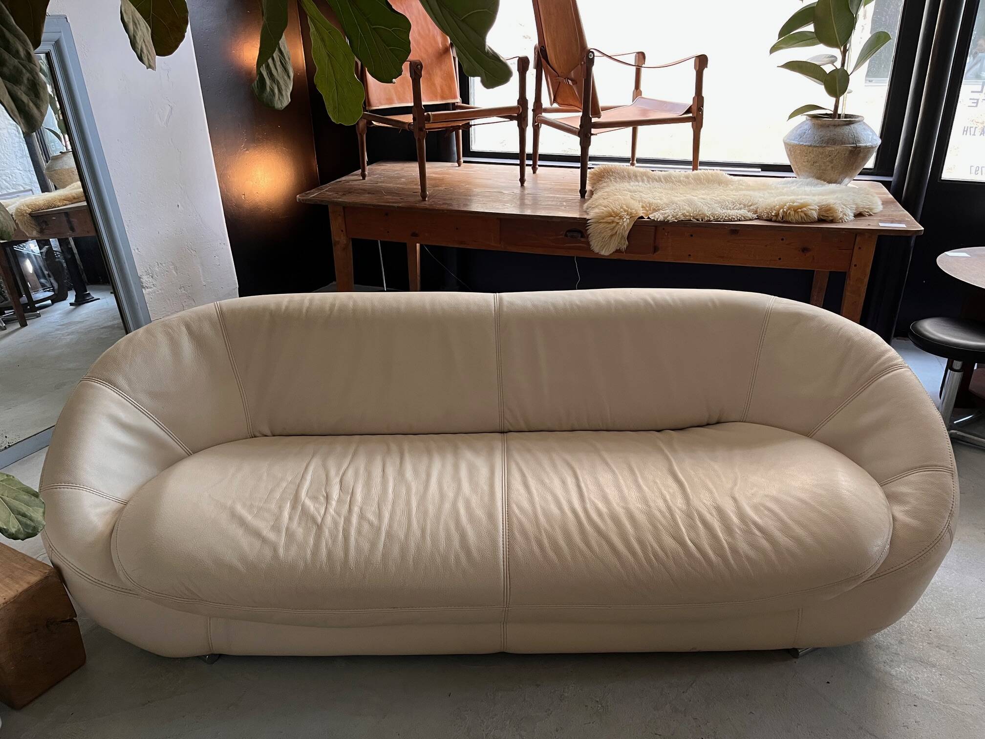 Rounded off-white leather sofa