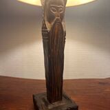 Old lamp with carved wooden base representing a wise man