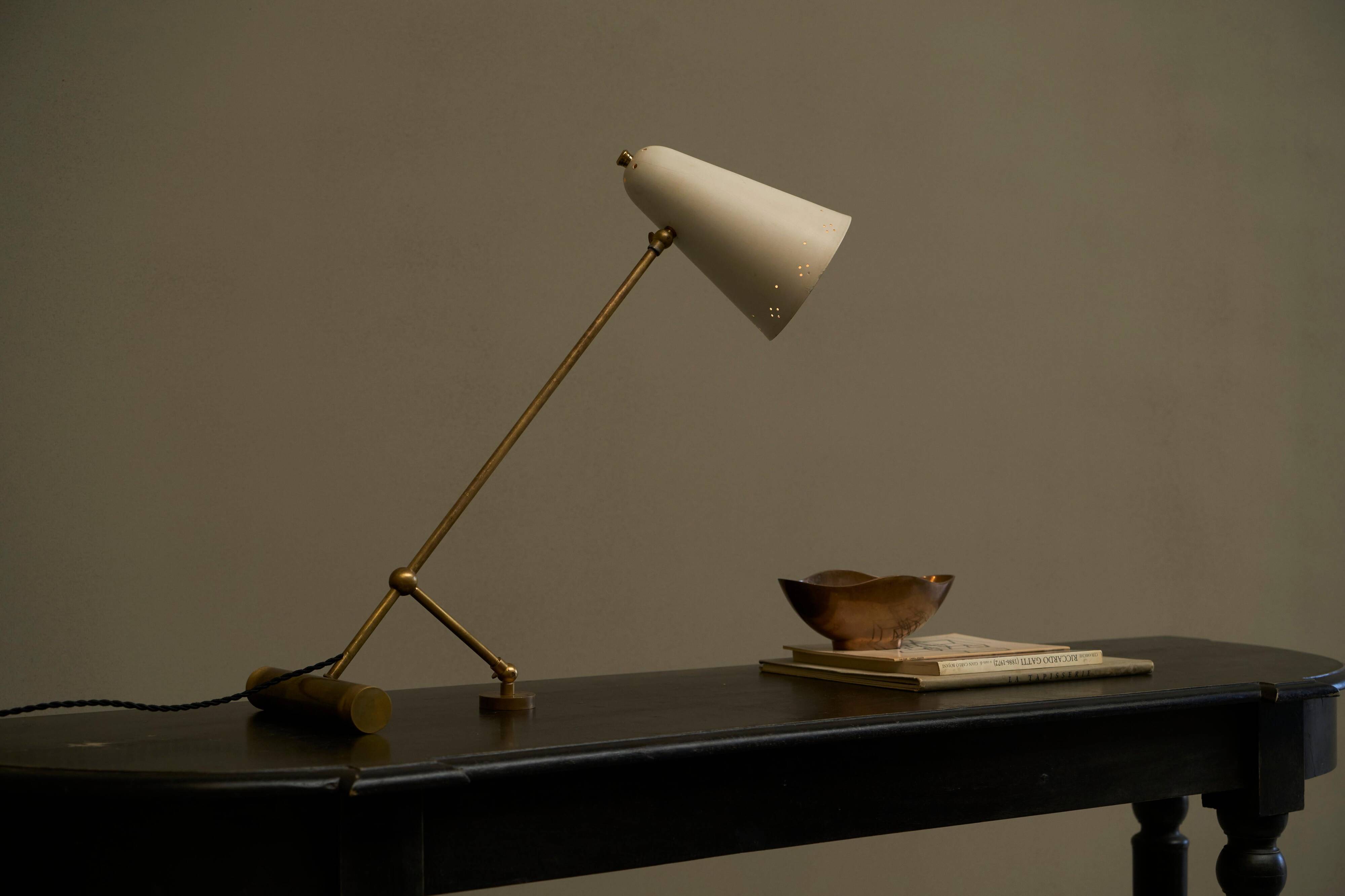 Mid Century adjustable table lamp with perforated shade from the 1950s.