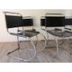 Series of 6 minimalist chairs in chrome metal and black leather around 1970