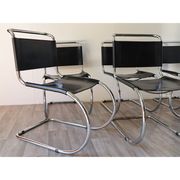Series of 6 minimalist chairs in chrome metal and black leather around 1970