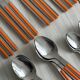 24 vintage stainless steel and orange plastic cutlery sets