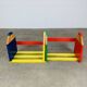 Modular wall-mounted pencil shelf in Pierre Sala style, for children.