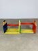 Modular wall-mounted pencil shelf in Pierre Sala style, for children.