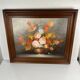 Vintage decorative table featuring a floral still life, signed Frederik.