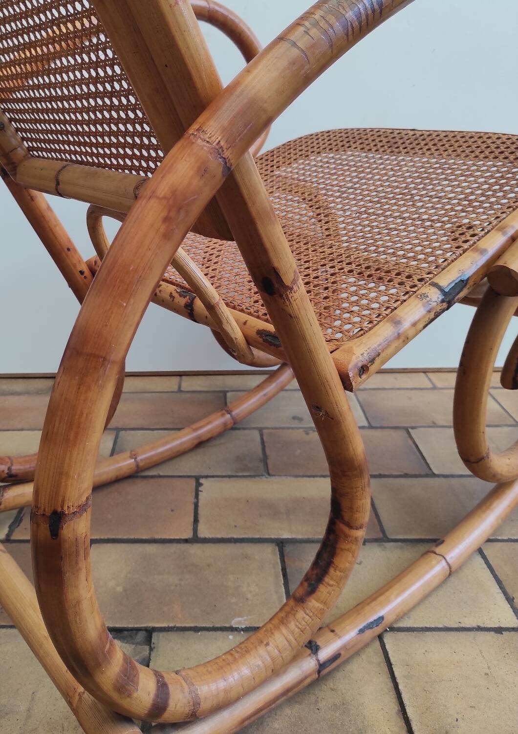 Vintage rocking chair in rattan and cane.