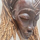 Chokwe Mwana Pwo mask in carved wood with a dark patina and rope hair