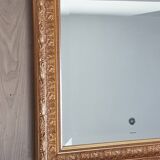 Mirror in gilded stucco wood and beveled glass