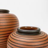 Pair of Elchinger ball vases with asymmetrical black stripes on an auburn background
