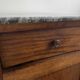 Vintage bedside table in the shape of a wooden column and a gray marble top