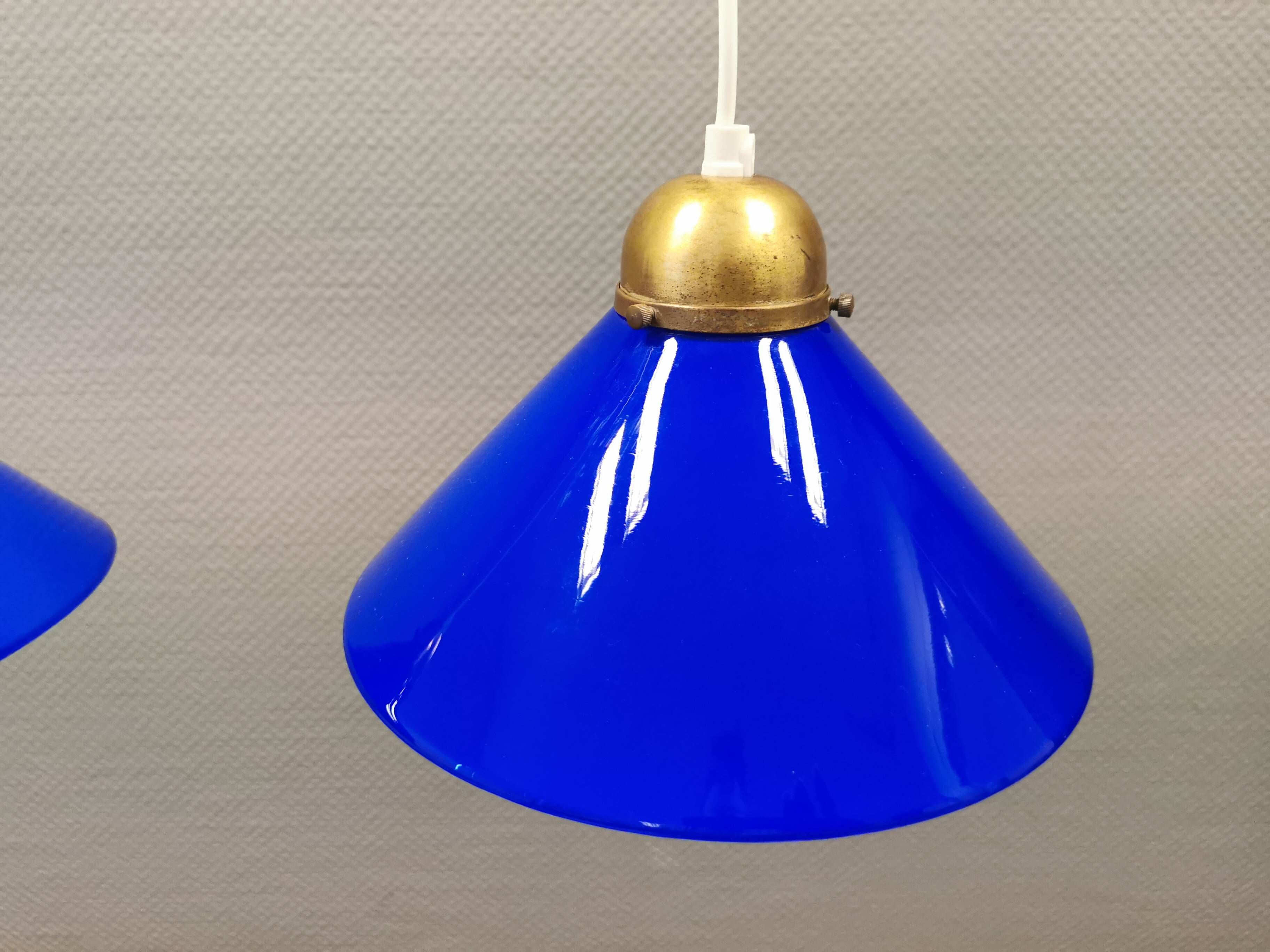 Two lamps in double layered glass with brass top. Danish and estimated from the 1960s