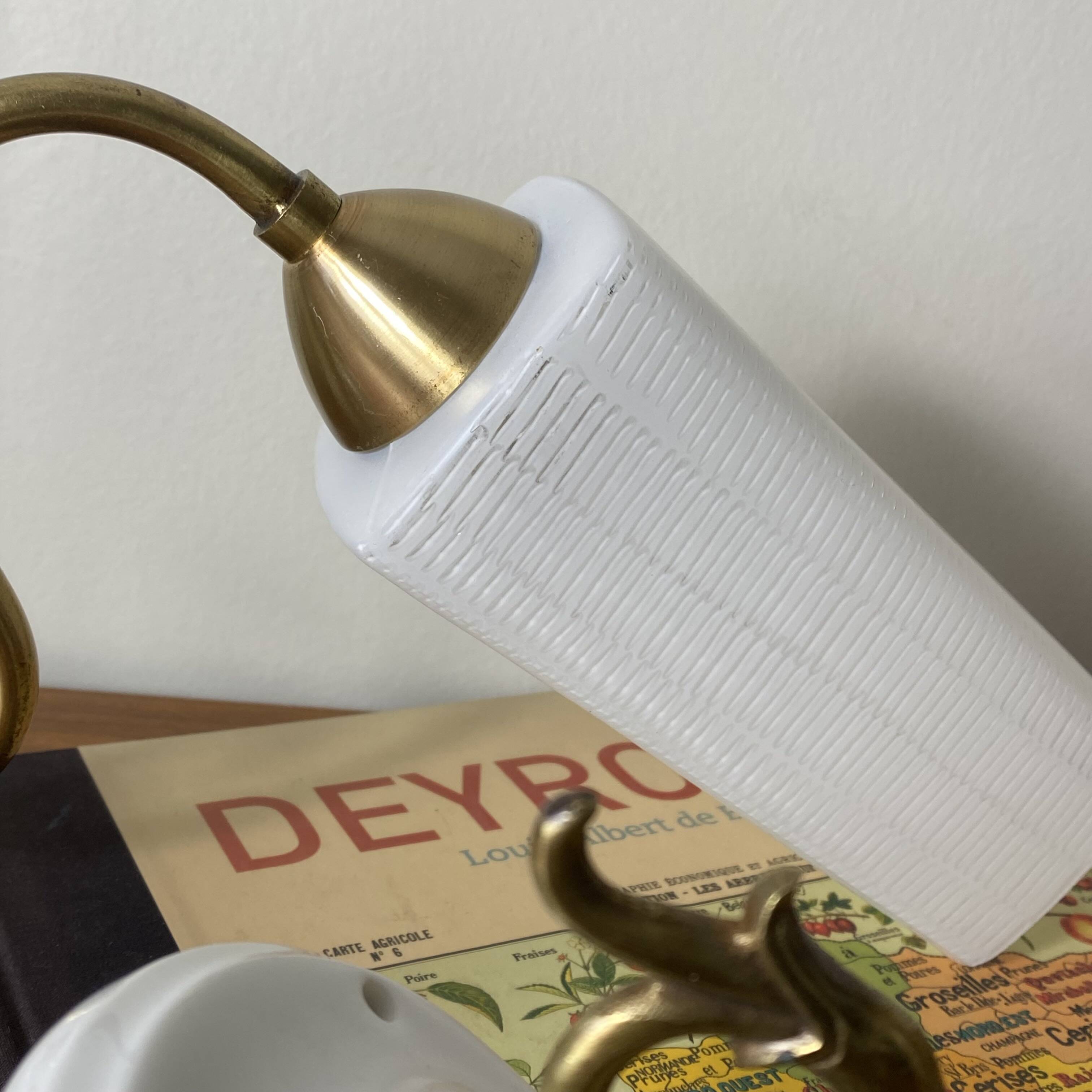 Pair of swan neck wall lights in brass, white glass and porcelain.