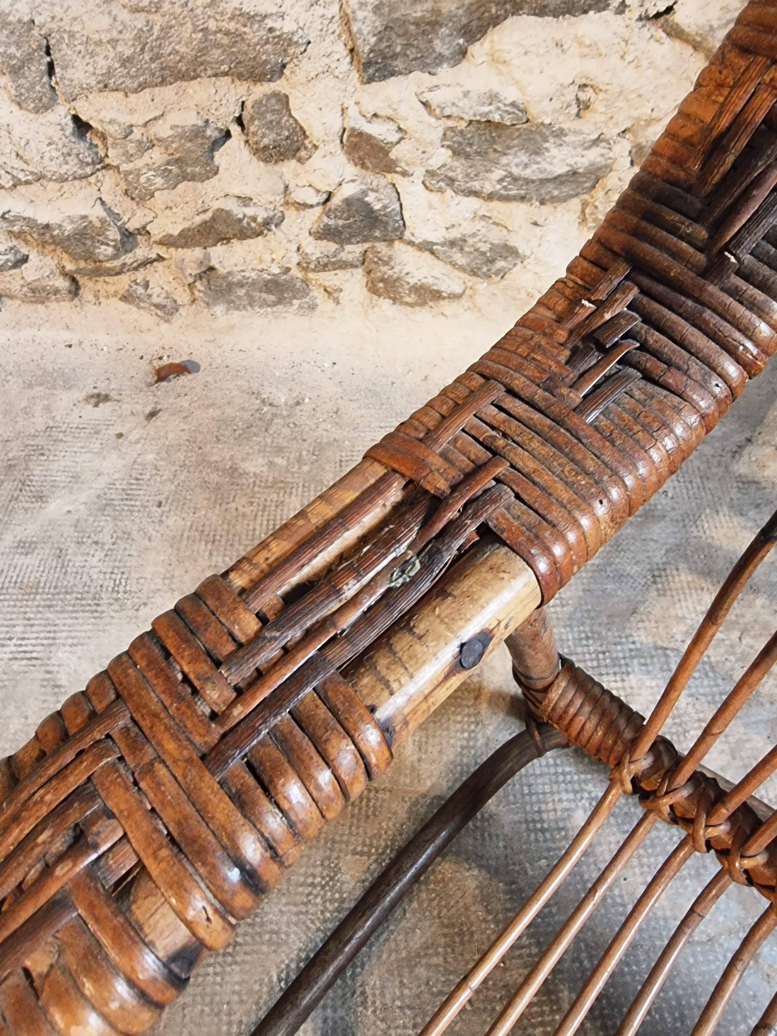 Vintage rattan lounge set, French wicker armchairs and round table, circa 1930–1950.