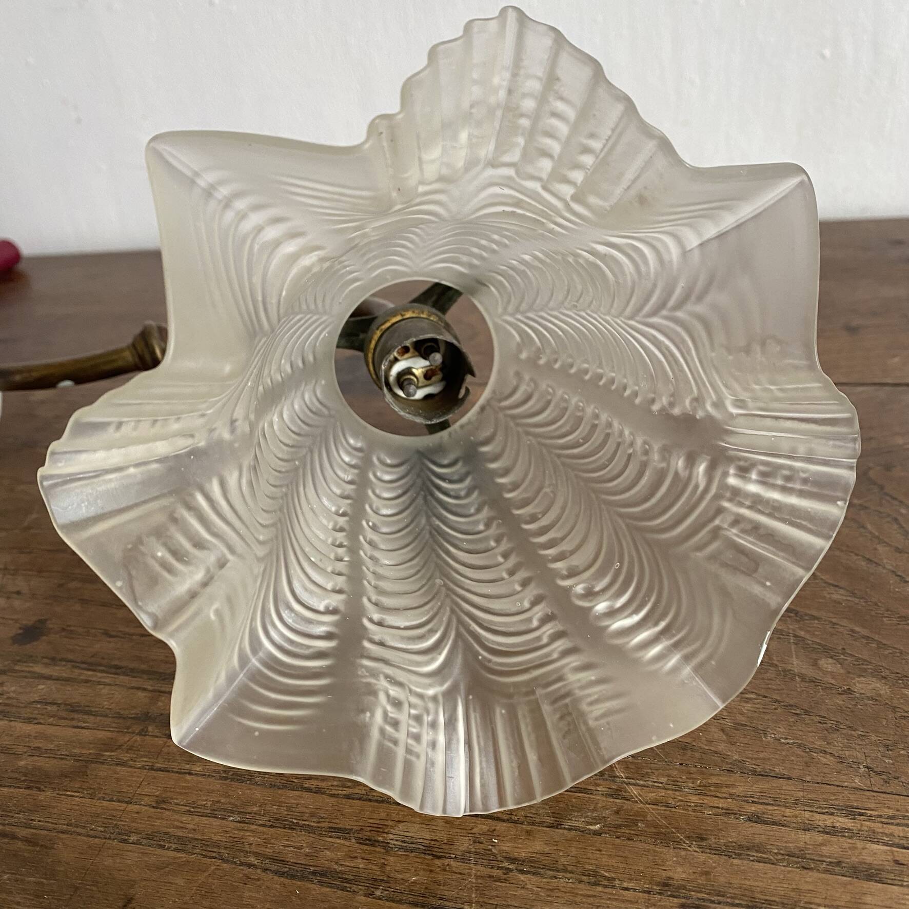 Antique swan neck wall light in brass and porcelain with a glass shade.