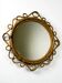Miroir ovale en rotin et bambou espagnol, vers les années 1960.