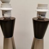 Two table lamps made of dark-stained wood with silver detail in the middle.