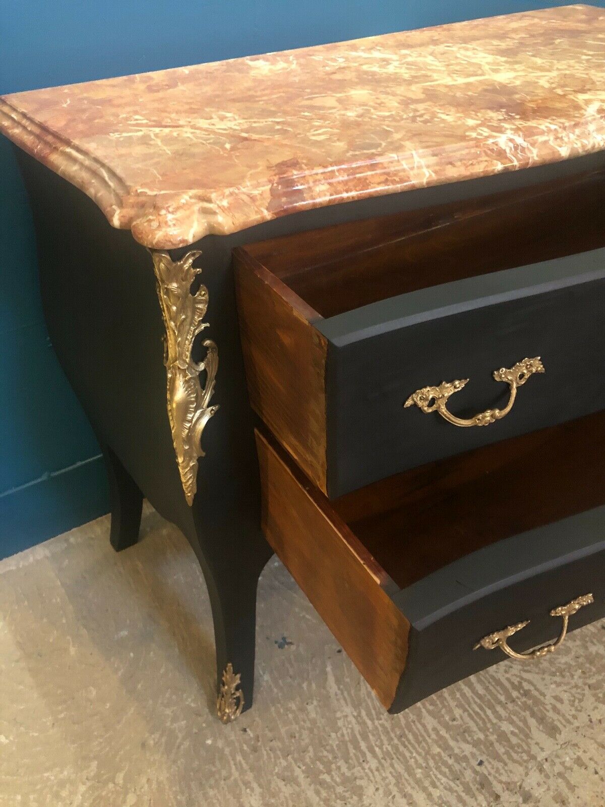 Louis XV style curved black matte commode with gilded bronze ornamentation from the 1950s.