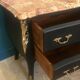 Louis XV style curved black matte commode with gilded bronze ornamentation from the 1950s.