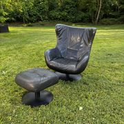 Egg chair style armchair and its ottoman.