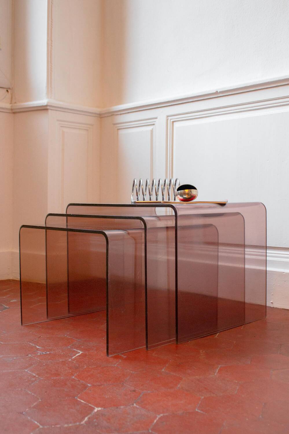 Vintage trio of nesting tables in smoked plexiglass by Michel Dumas, year.