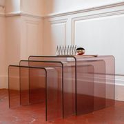 Vintage trio of nesting tables in smoked plexiglass by Michel Dumas, year.