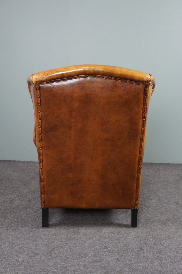 Antique armchair in patinated sheepskin