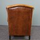 Antique armchair in patinated sheepskin