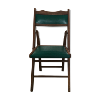 Folding wooden chair and green skaï