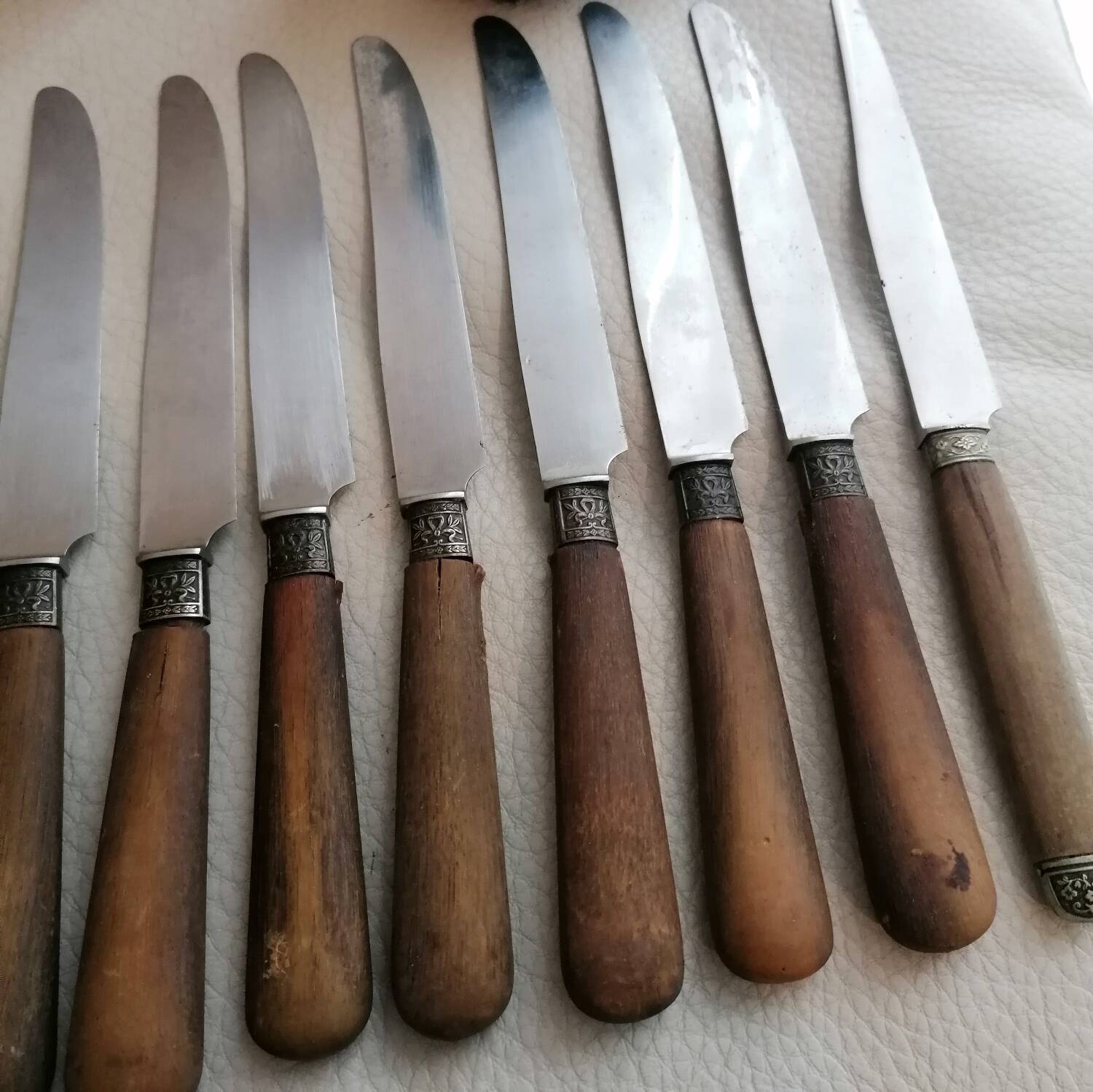 Old table knives and dessert knives, wooden handles, stainless steel blades
