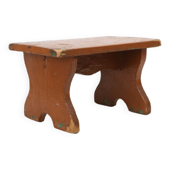 French rustic low church stool in terracotta painted wood, ca. 1900
