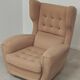 Beige wingback armchair and TVAR footrest, former Czechoslovakia.