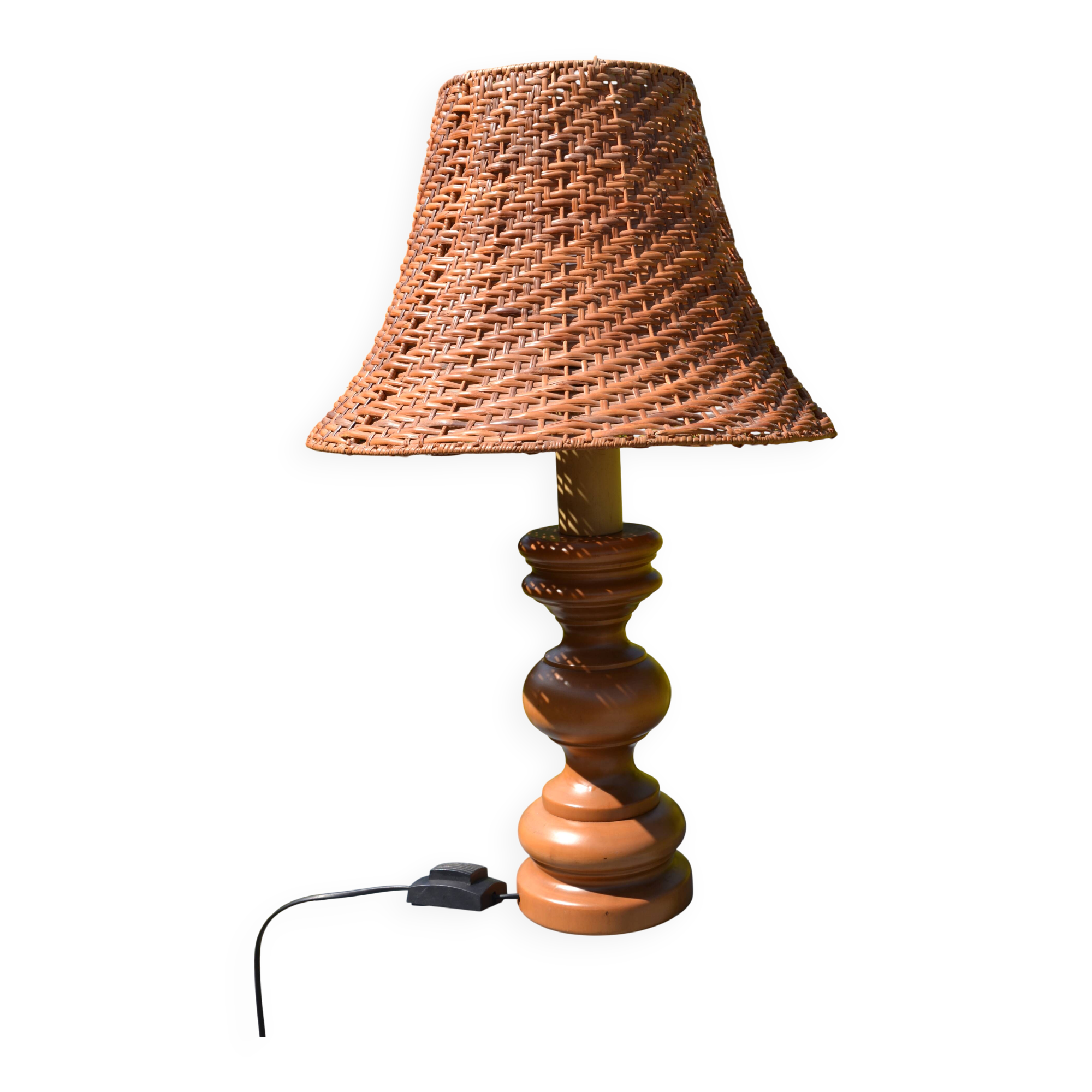 Large wooden lamp with a woven rattan shade.