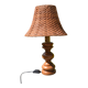 Large wooden lamp with a woven rattan shade.