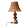 Large wooden lamp with a woven rattan shade.